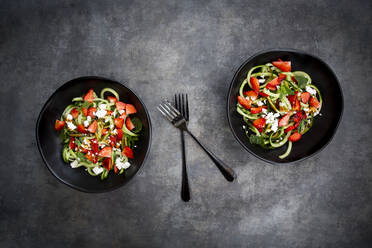 Two bowls of strawberry cucumber salad with feta, mint and balsamico vinegar - LVF08190