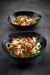 Two bowls of strawberry cucumber salad with feta, mint and balsamico vinegar - LVF08192