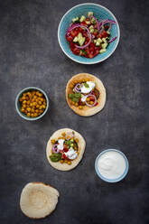 Ingredients for Sabich, pita bread with fresh vegetables, onions, yogurt and sauce - LVF08198