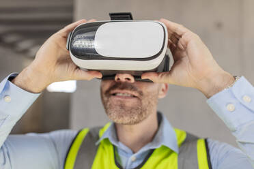 Architect with VR glasses at construction site - ZEF16144