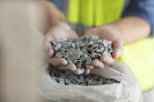 Worker holding gravel - ZEF16166