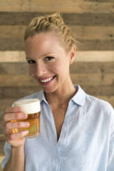 Portrait of blond woman with a glass of beer - JOSF03561