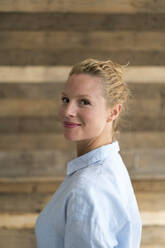 Portrait of beautiful blond woman, wooden background - JOSF03580