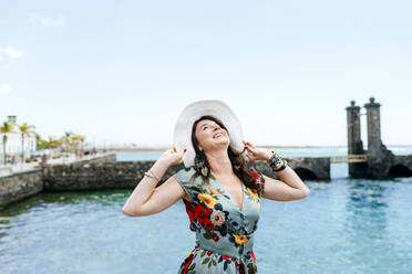 Woman with white sun hat in Arrecife, Spain - KIJF02500
