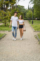 Young couple walking together in a park - MGIF00635