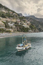 Boat sailing near Positano cityscape, Amalfi Peninsula, Italy - BLEF12043