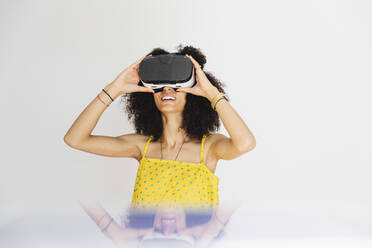 Young woman wearing virtual reality glasses - MRAF00415