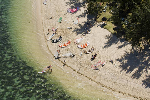 Aerial view of kitesurfers on beach stock photo