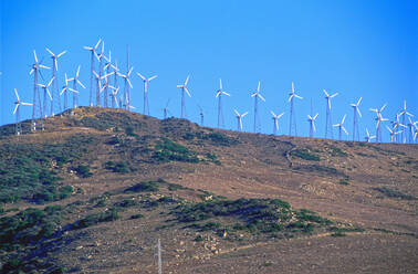 Wind turbines on hilltop in remote landscape - BLEF12115