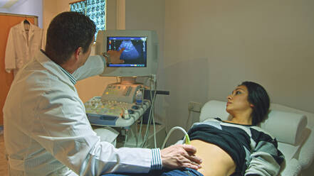 Doctor using ultrasound on pregnant woman - BLEF12123