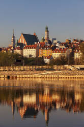 City skyline at sunrise, view across the Vistula River to the Old Town, Warsaw, Poland - ABOF00433