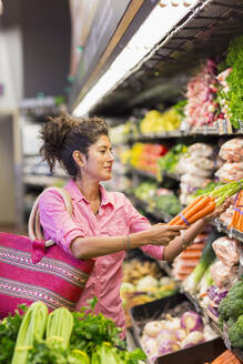 Hispanic woman shopping at grocery store - BLEF12216