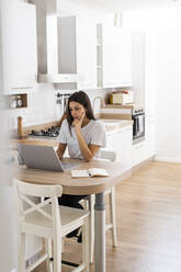 Young woman using laptop at home - GIOF06927