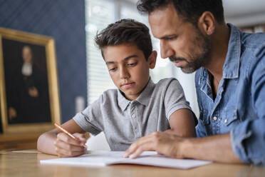 Father helping son doing homework - DIGF07743