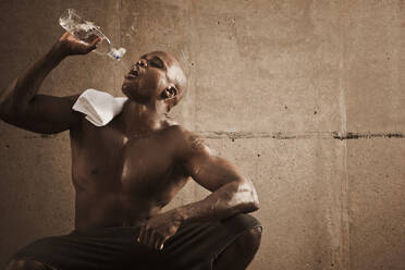 African American man drinking water after exercise - BLEF12252