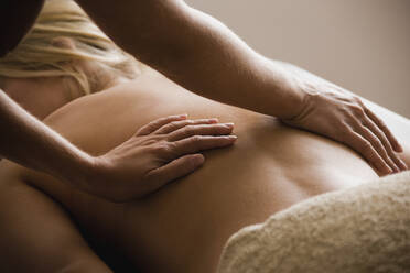 Caucasian woman receiving massage - BLEF12271