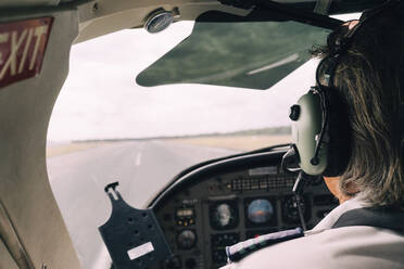 Pilot and dashboard of a small plane on the runway ready to take off - GEMF02995