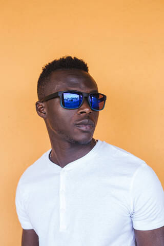 Porträt eines jungen Mannes mit weißem T-Shirt und Sonnenbrille, lizenzfreies Stockfoto