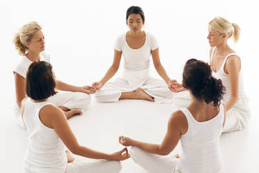 Women meditating in yoga class - BLEF12343