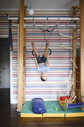 Boy doing gymnastics at home - EYAF00315