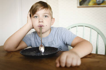 Portrait of a boy with blueberry jam in his face - EYAF00330