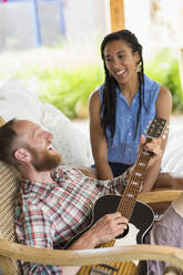 Couple playing music in backyard - BLEF12617
