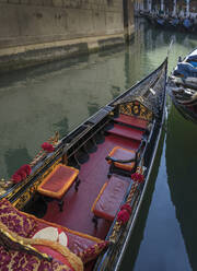 Empty gondola sailing on Venice canal, Veneto, Italy - BLEF12749