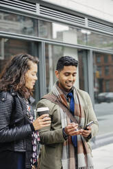 Couple using cell phone in city - BLEF12779