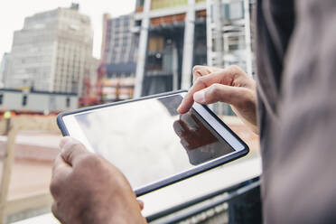 Indian businesswoman using digital tablet outdoors - BLEF12806