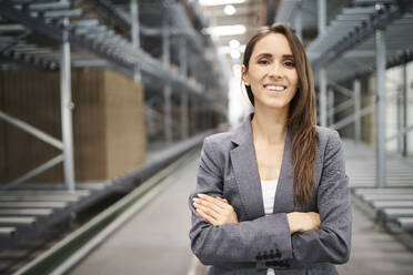 Portrait of smiling businesswoman in a factory - BSZF01200