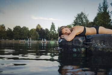 Young woman lying on bathing platform - GUSF02318