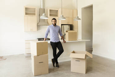 Mixed race man standing in new house - BLEF13049