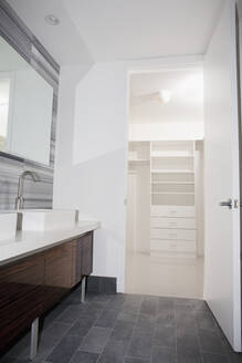 Door open to walk-in closet from modern bathroom - BLEF13228