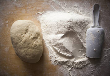 High angle view of flour and dough on table - BLEF13400