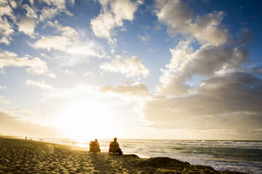 People relaxing on beach at sunrise - BLEF13429