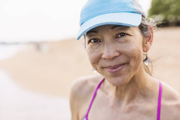 Japanese woman smiling on beach - BLEF13452