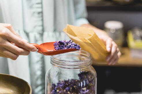 Young woman with shovel and dried flowers - AFVF03622