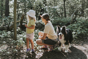 Mother with daughter and dog in a forest - DWF00459