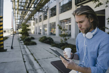 Junger Mann mit Tablet in der Stadt - KNSF06167