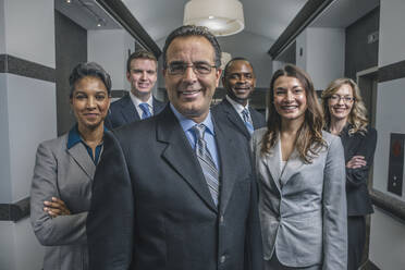 Business people smiling in office corridor - BLEF13522