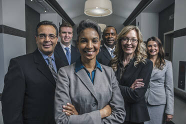 Business people smiling in office corridor - BLEF13523