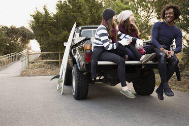 Friends having coffee together in truck bed - BLEF13607