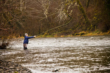 Man fly fishing in rural river - BLEF13638