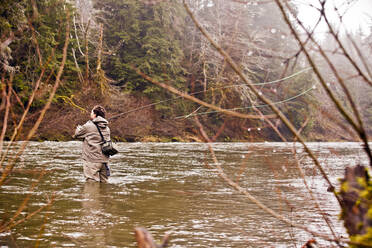 Mann beim Fliegenfischen in ländlichem Fluss - BLEF13640