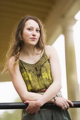 Caucasian teenage girl leaning on banister - BLEF13654