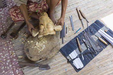Craftsperson shaping wooden piece in studio - BLEF13718