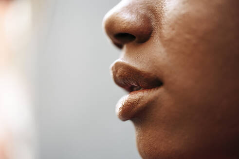 Nose, lips and cheek of young woman, close-up - JSMF01196