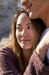 Happy young woman hugging boyfriend outdoors - GEMF03071