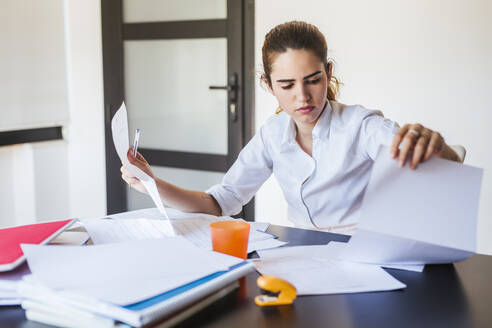 Female student learning at desk at home - LJF00595