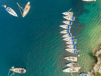 Aerial view of boats lined up in harbor on Ionian island , Greece. - AAEF00120